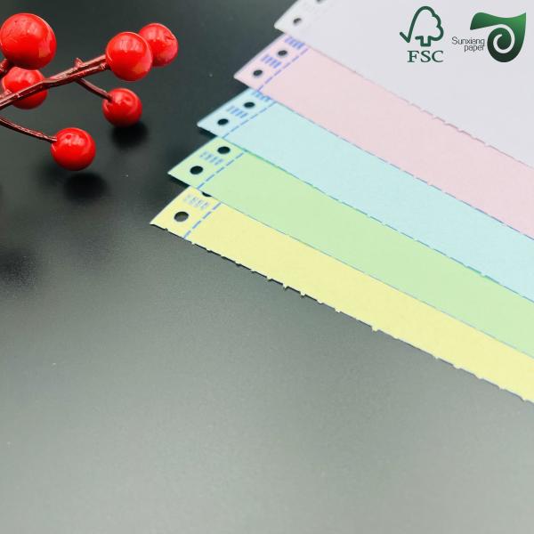 Multi-colored NCR carbonless paper stack showing various pastel colors